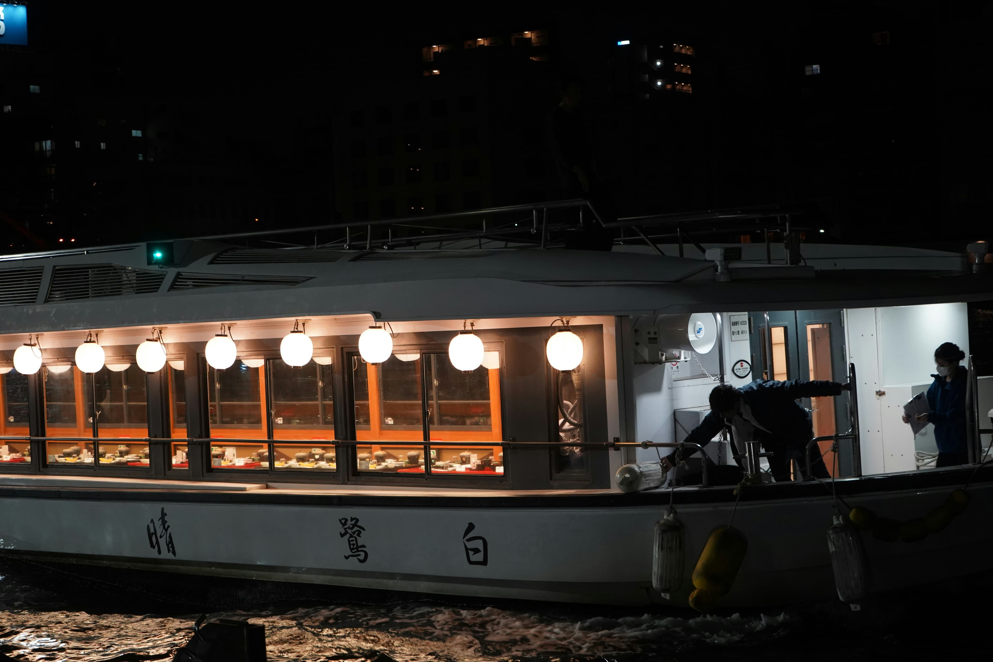 Cruise boat with lit windows at night