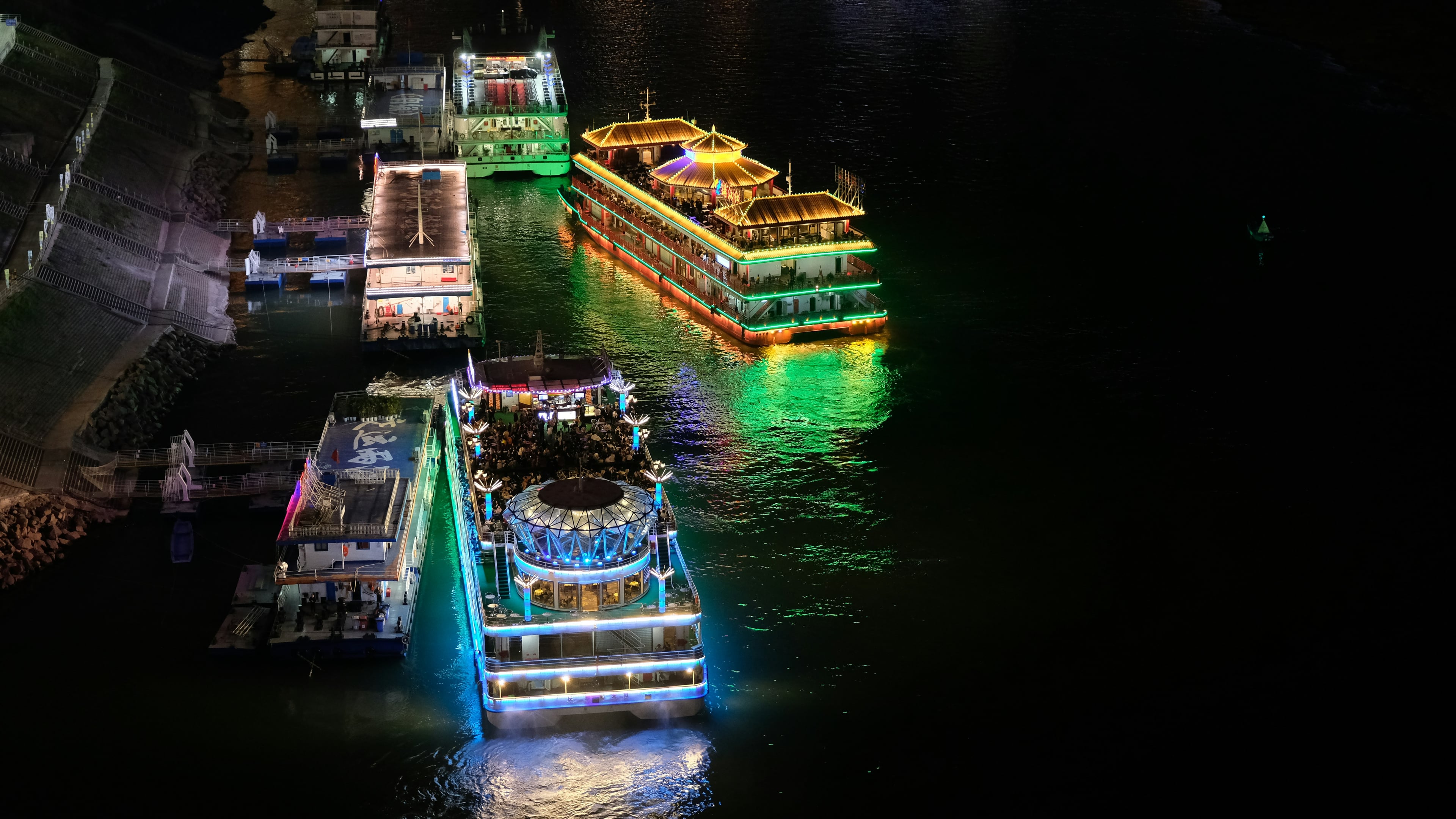Illuminated cruise boats on the river at night
